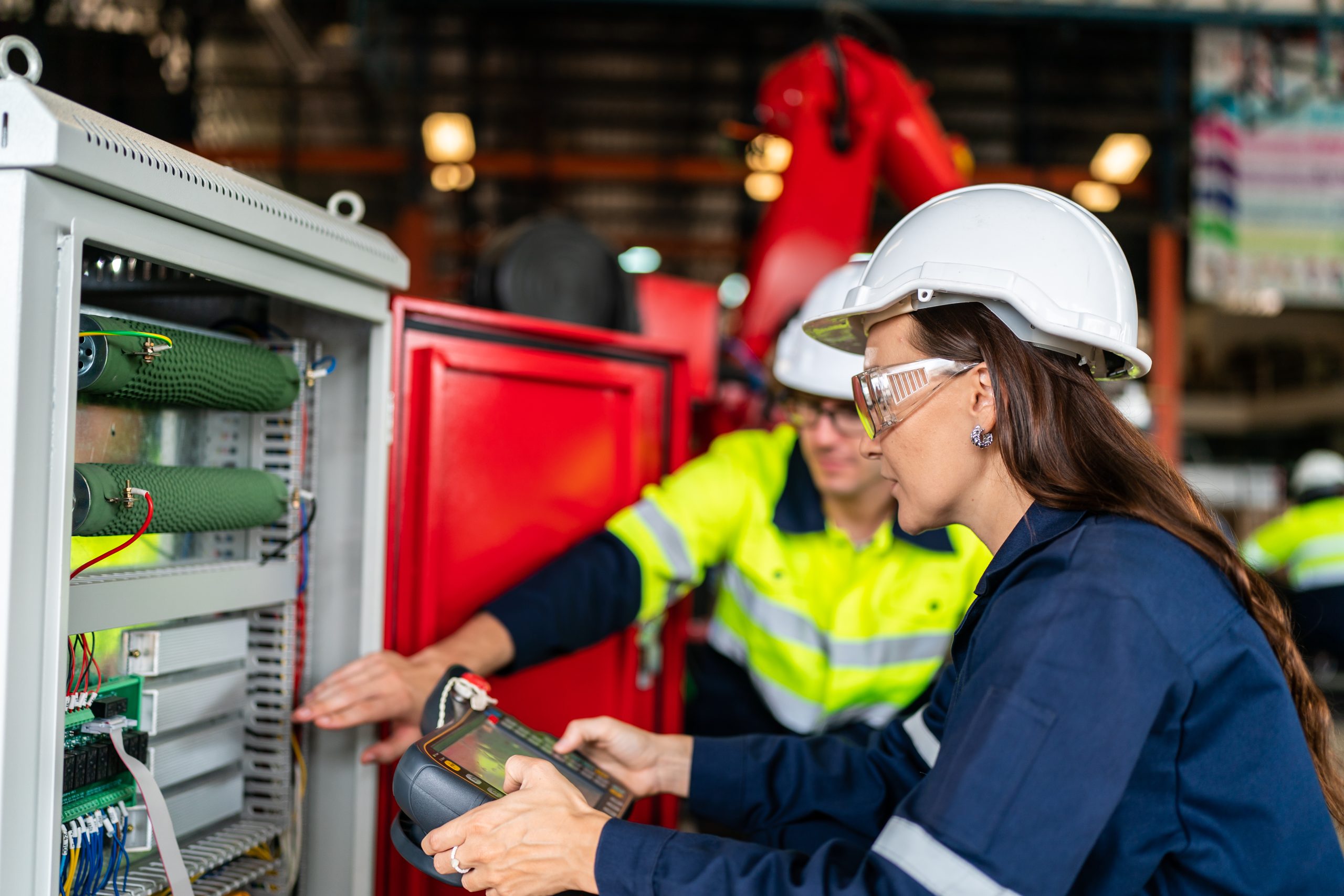 professional technician engineer working in industrial manufacturing factory, checking equipment